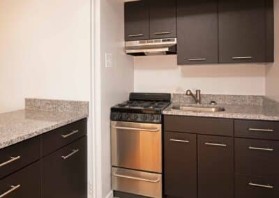 Kitchen with black cabinets and granite countertops